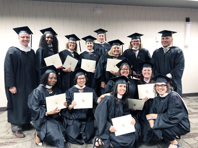 George Diaz poses with the follow members of his graduating class from the M.A. in Human Development program in 2010.