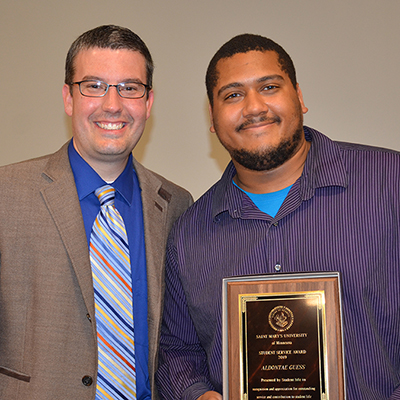 Tim Gossen, vice president for Student Affairs and Student Life, presents Aldontae Guess with the 2019 Student Service Award.