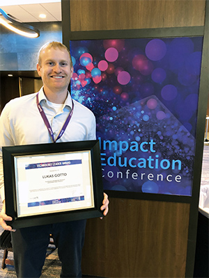 Lukas Gotto stands with the 2019 Technology Leader of the Year award at the Impact Education Conference in December in Minneapolis.