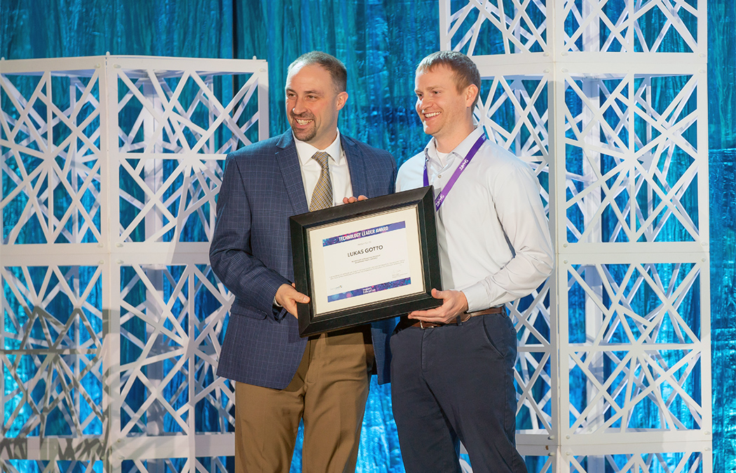 Lukas Gotto stands with Chad Coauette, executive director/CEO of Sourcewell Technology, after being presented with the award.