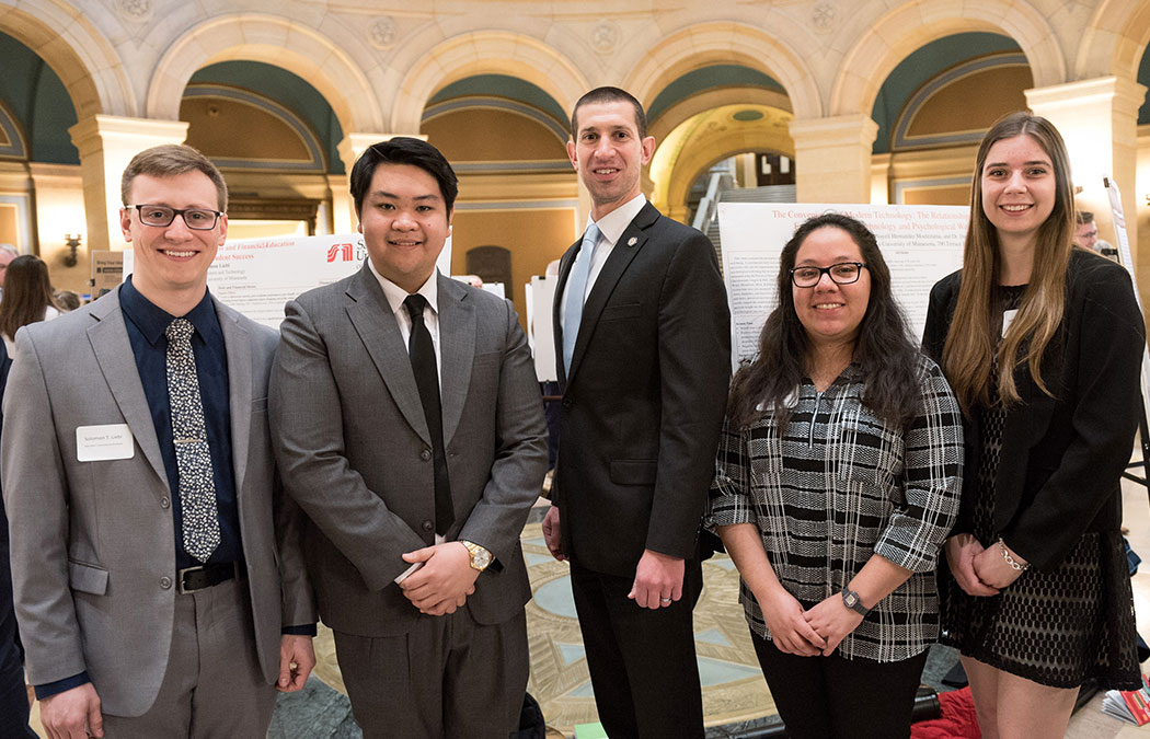 Four students share research with legislators at the Minnesota Capitol