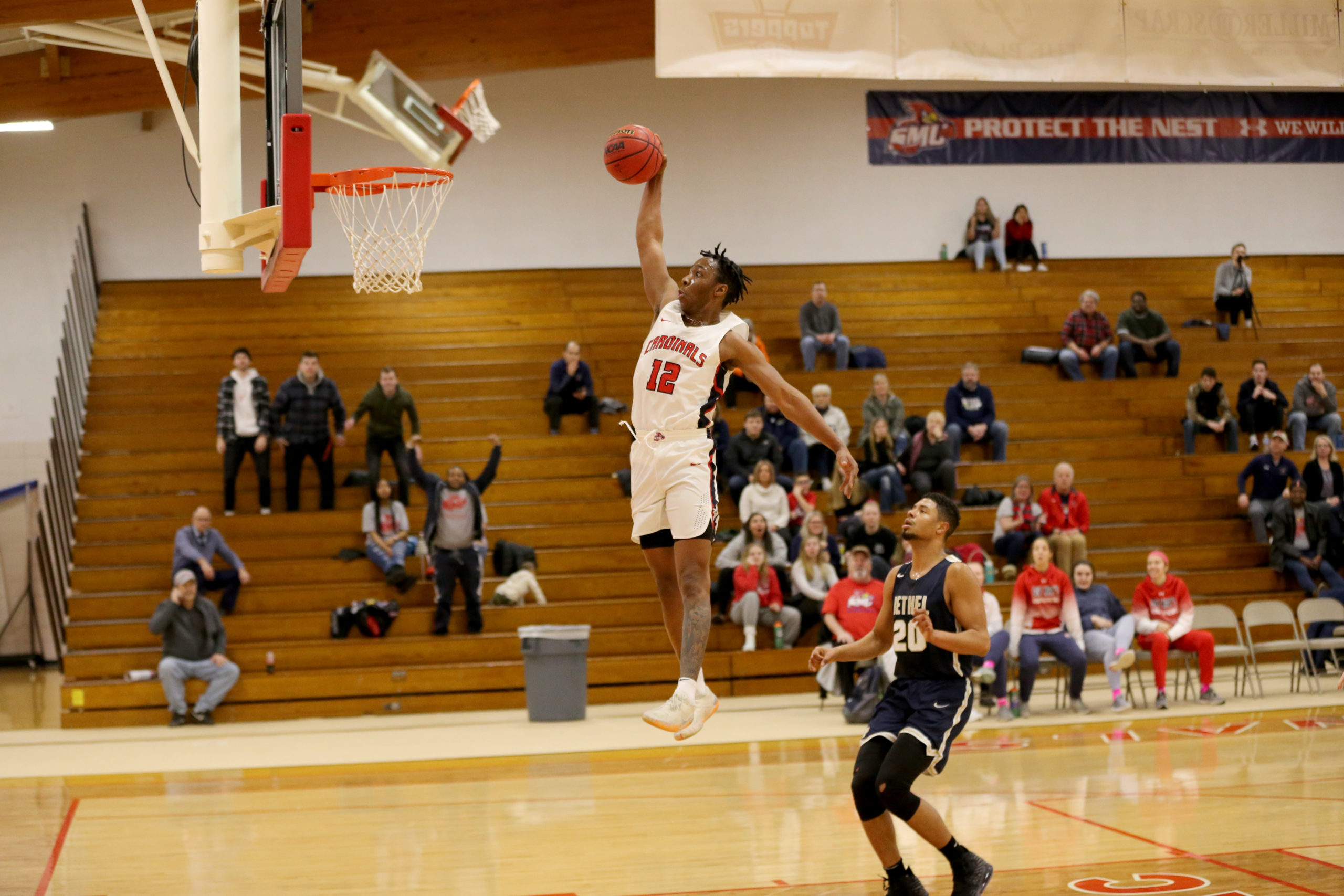 This is a photo of Kareem Anthony-Bello extending his arm in preparation for a slam dunk against Bethel.
