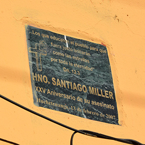 A photo of a plaque that marks the spot where Blessed James Miller, FSC, was shot and killed on Feb. 13, 1982, while fixing this wall.