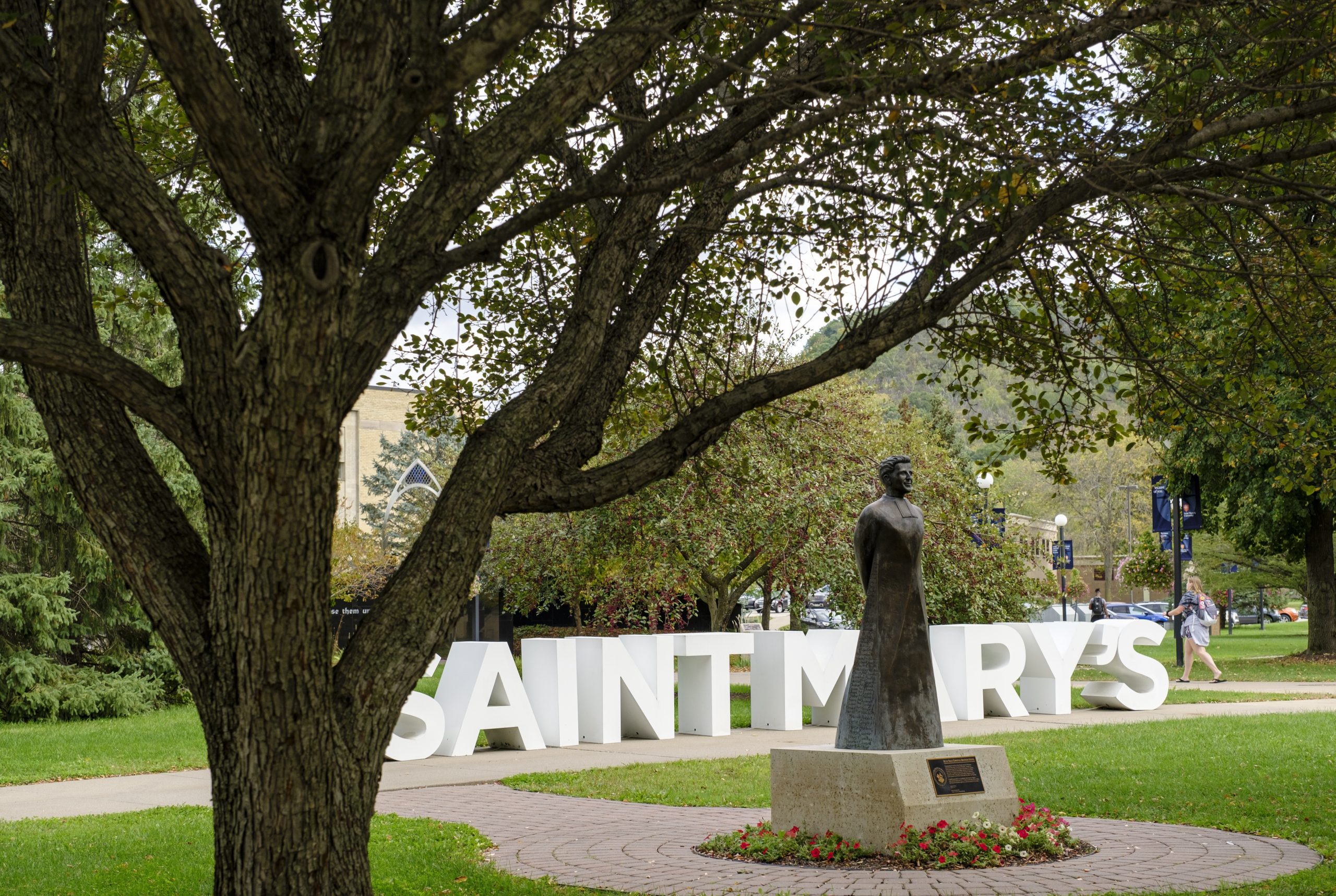 Saint Mary's letters behind statue with tree in the foreground